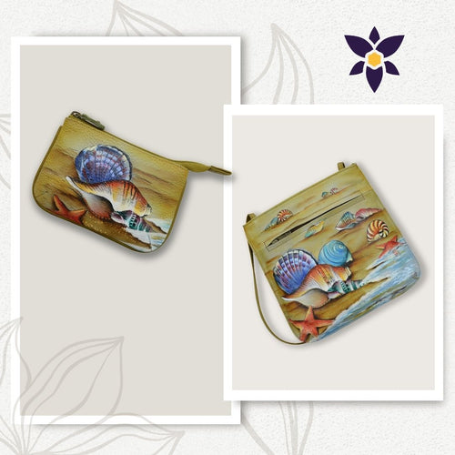 Two bags with sea shell and starfish designs. The left is a small zippered pouch; the right is a larger mini crossbody bag with front pockets, featuring exquisite hand painted artwork. Both are placed on a white background with floral accents. This set is the Bundle of Slim Crossbody with Medium Zip Pouch - 452-1107 by Anuschka.