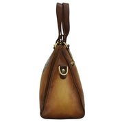 Side view of a brown genuine leather Anuschka Wide Organizer Satchel - 695 handbag with a shoulder strap and metallic hardware.
