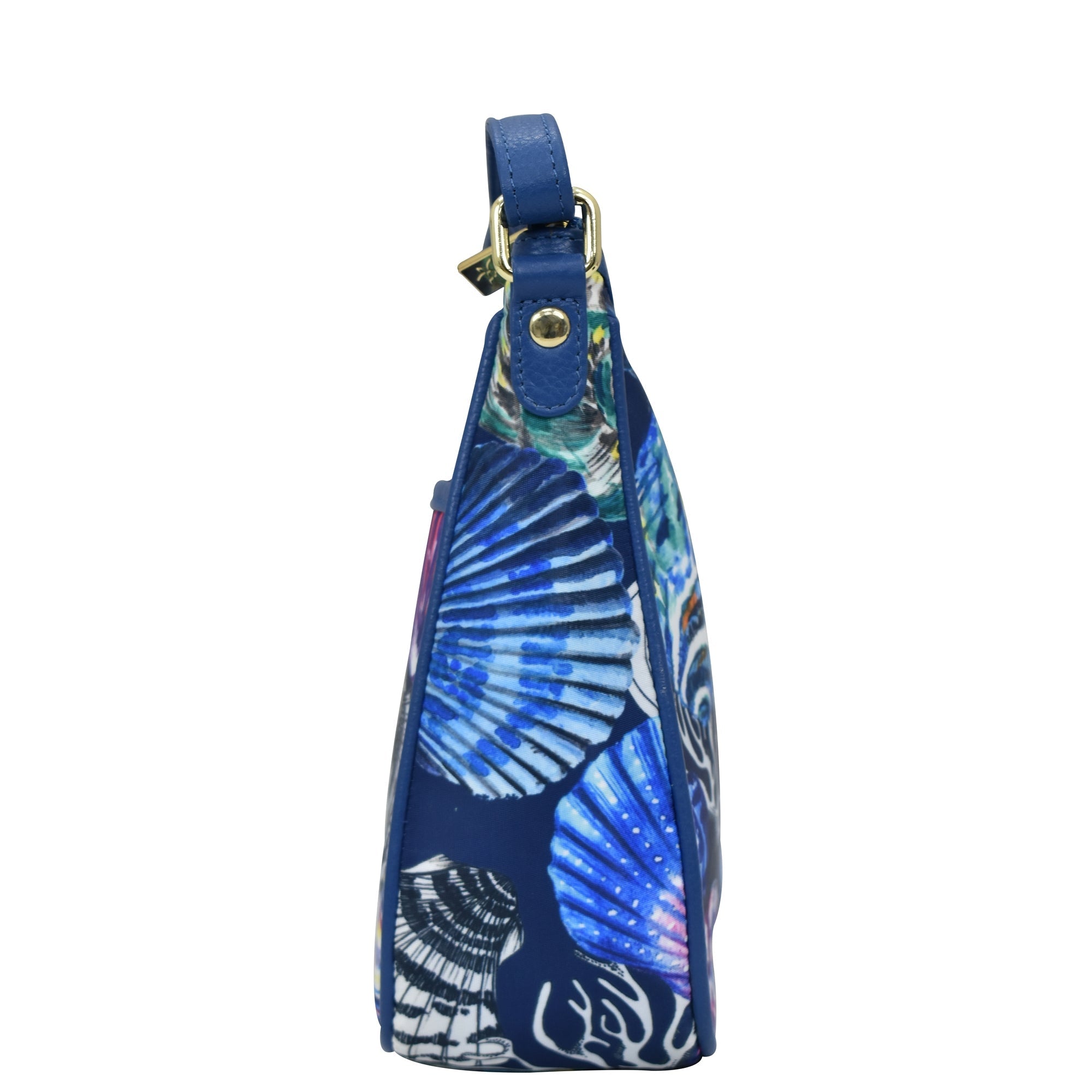 Side view of an Anuschka Fabric with Leather Trim East/West Hobo - 12013 purse with an adjustable handle and a seashell pattern on a white background.