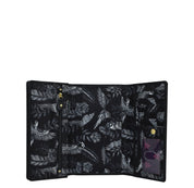 Anuschka's Fabric with Leather Trim Three-Fold RFID Wallet - 13007, featuring a tropical bird and foliage print, opens to show internal compartments including card slots and zip pockets.