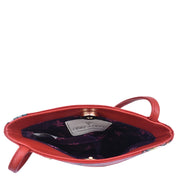 Open Mini Double Zip Travel Crossbody - 448 handbag in orange leather with a floral interior lining shown from a top-down perspective against a white background by Anuschka.