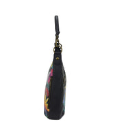 Side view of a Anuschka Convertible Slim Hobo With Crossbody Strap - 662 with a zipper closure and an adjustable crossbody strap.