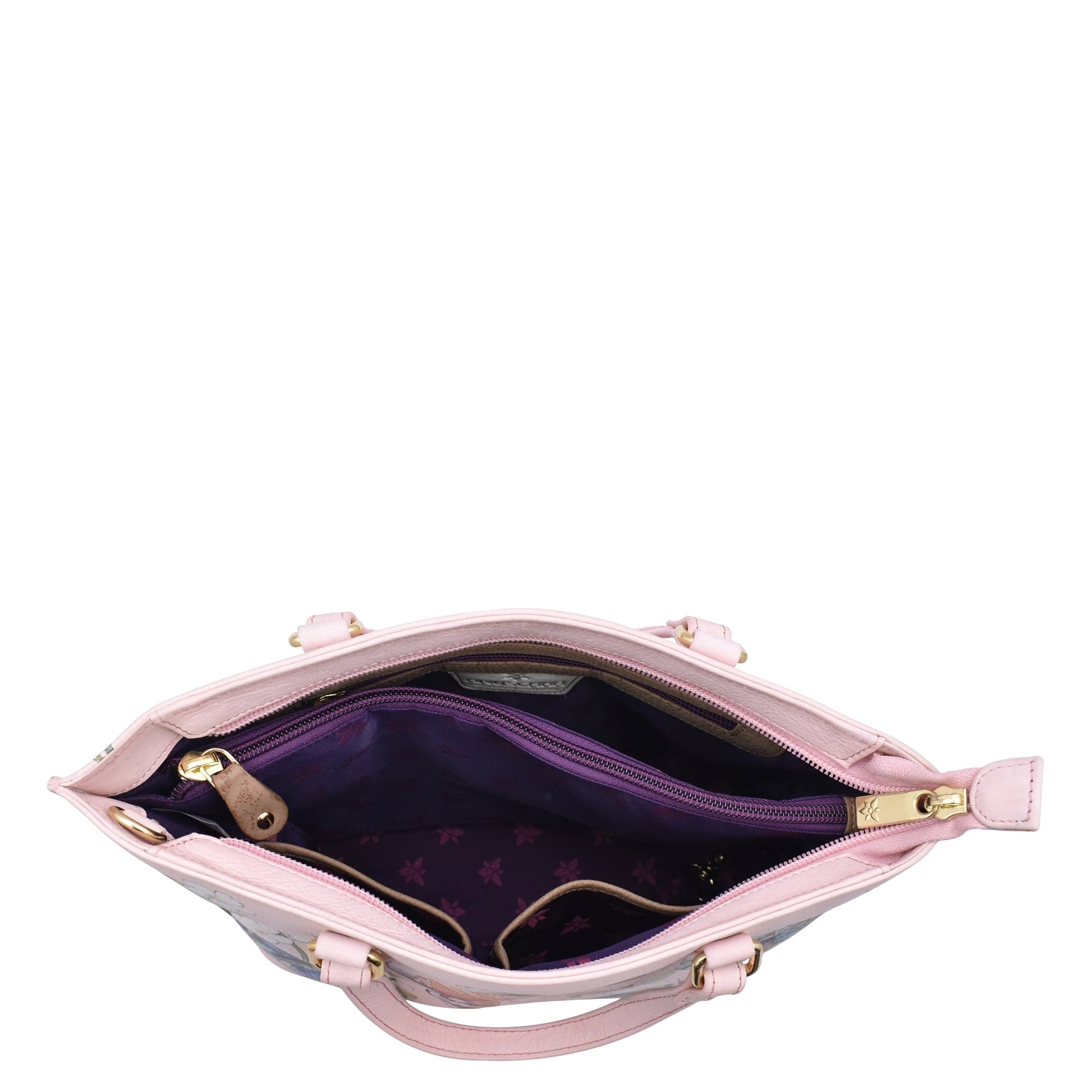 An open, empty Anuschka 693 pink leather tote bag with zippered compartments against a white background.