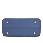 Blue rectangular Anuschka genuine leather Medium Tote - 693 laying on its side with protective metal studs.