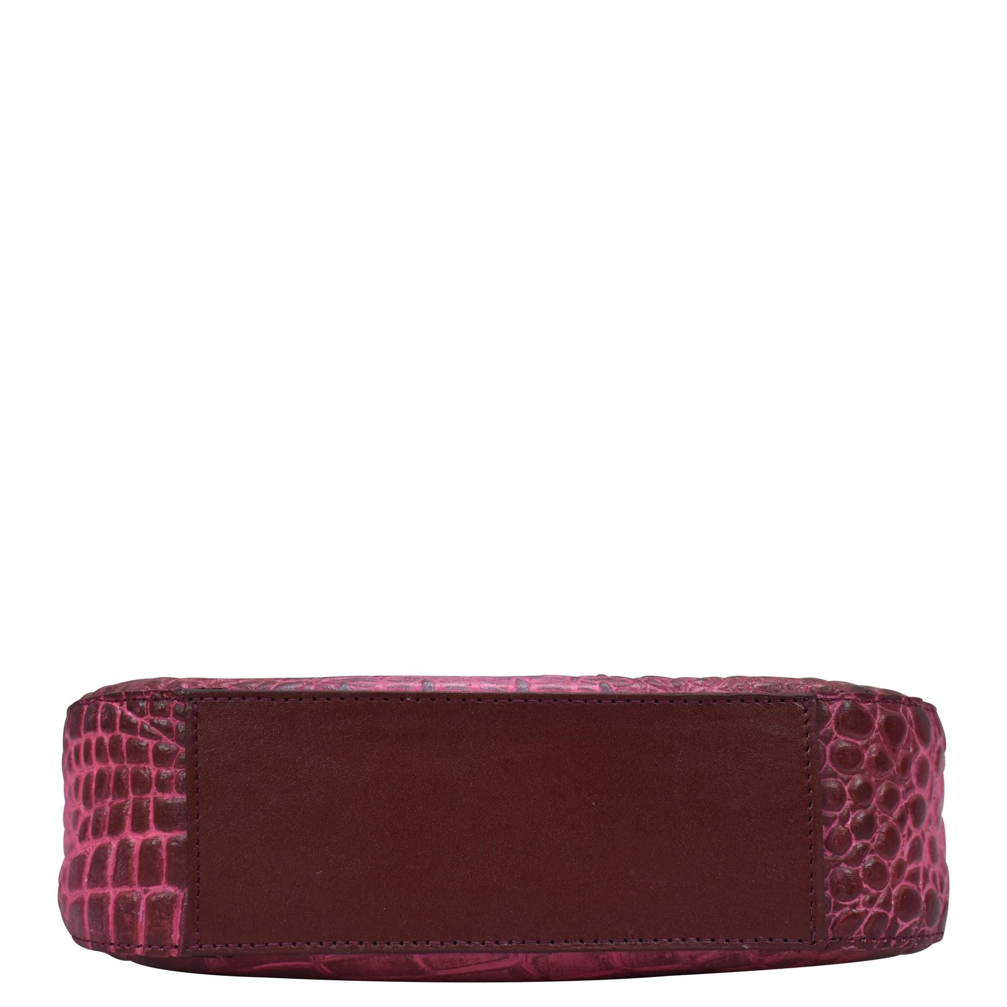 A side view of a burgundy Anuschka Small Convertible Hobo - 701 genuine leather crocodile embossed wallet on a white background.