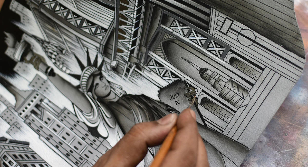 A person is drawing a detailed black and white illustration of the Statue of Liberty amid various New York City buildings and architectural elements.