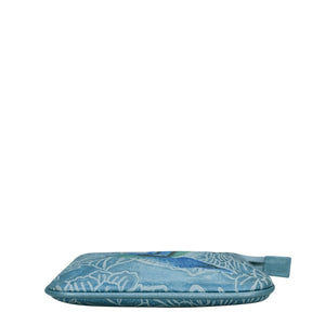 Blue floral ironing board cover with Anuschka Medium Zip Pouch - 1107 isolated on a white background.