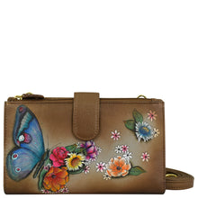 Load image into Gallery viewer, Anuschka&#39;s Cell Phone Case &amp; Wallet - 1113 is a brown leather accessory adorned with a painted design featuring a blue butterfly and vibrant flowers, complete with a detachable shoulder strap for added convenience.
