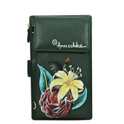 A green genuine leather cell phone case & wallet - 1113 with a front flap. It features floral artwork, including a yellow lily and a pink peony, and has the text "Anuschka" in white.