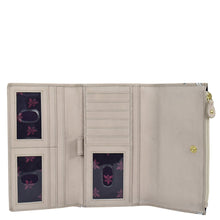 Load image into Gallery viewer, Beige full-grain leather Three Fold Clutch - 1136 by Anuschka open to display credit card holders and a clear id window.
