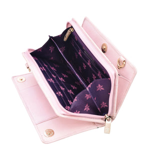 Open pink Anuschka organizer wallet crossbody with a floral pattern inside.