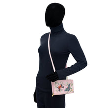 Load image into Gallery viewer, Mannequin wearing a navy blue outfit, black gloves, and showcasing an Anuschka Organizer Wallet Crossbody - 1149 with RFID protection.
