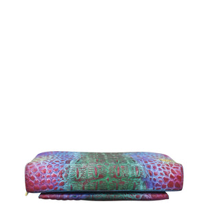 Anuschka Multicolored patterned bolster pillow with RFID protection on a white background.