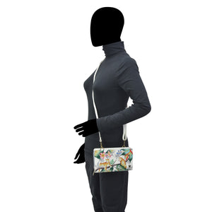 Mannequin displaying a grey outfit and an Anuschka Organizer Wallet Crossbody - 1149 with RFID protection.