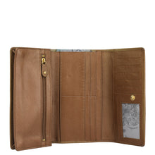 Load image into Gallery viewer, The Triple Fold RFID Clutch Wallet - 1150 by Anuschka is open, showcasing multiple card slots, a zippered compartment, and a clear ID window with a floral design in the bottom right corner. Enjoy added peace of mind with the RFID protection seamlessly integrated into this stylish tan genuine leather accessory.
