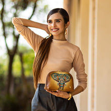 Load image into Gallery viewer, A smiling woman posing with an Anuschka Large Cosmetic Pouch - 1164.

