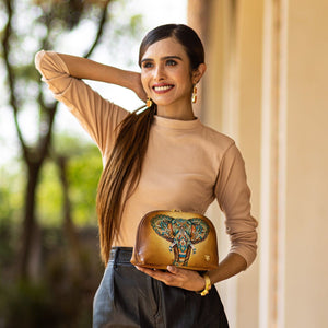 A smiling woman posing with an Anuschka Large Cosmetic Pouch - 1164.