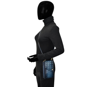 Mannequin wearing a turtleneck and trousers with a Anuschka Crossbody Phone Case- 1173 featuring RFID card holders.