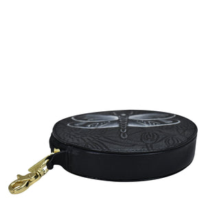 A black Anuschka round-shaped genuine leather purse with embossed designs and a gold-tone clasp.