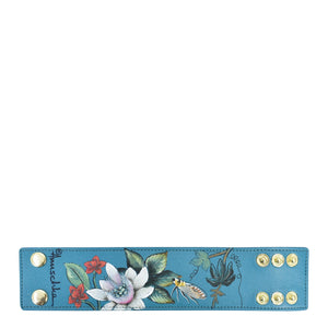 Blue floral hand-painted Anuschka leather cuff bracelet with snap closures.