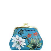 A blue coin purse with a metal clasp, adorned with a floral design featuring white, red, and green flowers. "Anuschka" is written near the top, enhancing its vintage charm.