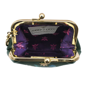 Open green floral-patterned Clasp Pouch With Key Fobs - 1177 from Anuschka with a gold clasp and purple interior lining.