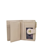 An open beige Two Fold Organizer Wallet - 1178 by Anuschka, made of genuine leather, featuring multiple card slots, a clear ID window, a zippered coin pocket, and a button closure adorned with a small star emblem—perfect for minimalists.