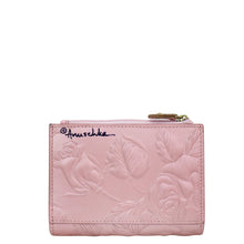 Load image into Gallery viewer, Pink embossed Anuschka Two Fold Organizer Wallet - 1178 with floral pattern and brand logo.
