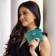 A smiling woman holding an Anuschka Two Fold Organizer Wallet - 1178.