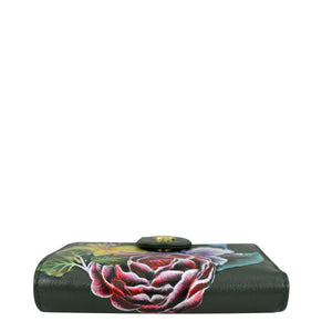 A Two Fold Organizer Wallet - 1178 from Anuschka in black genuine leather featuring a hand-painted red, pink, and green floral design on the front.