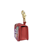 A small, genuine leather keychain pouch with a gold clasp and floral design on the side, perfect for holding your Airpod Pro Case - 1179 by Anuschka.