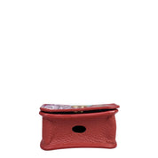 A small, red, genuine leather pouch with a flap closure and a central circular opening on one side, perfect for carrying your Anuschka Airpod Pro Case - 1179.