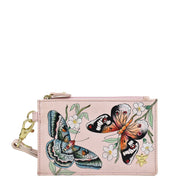 A pink Anuschka Card Holder with Wristlet - 1180, featuring a butterfly and floral print design and RFID protection.