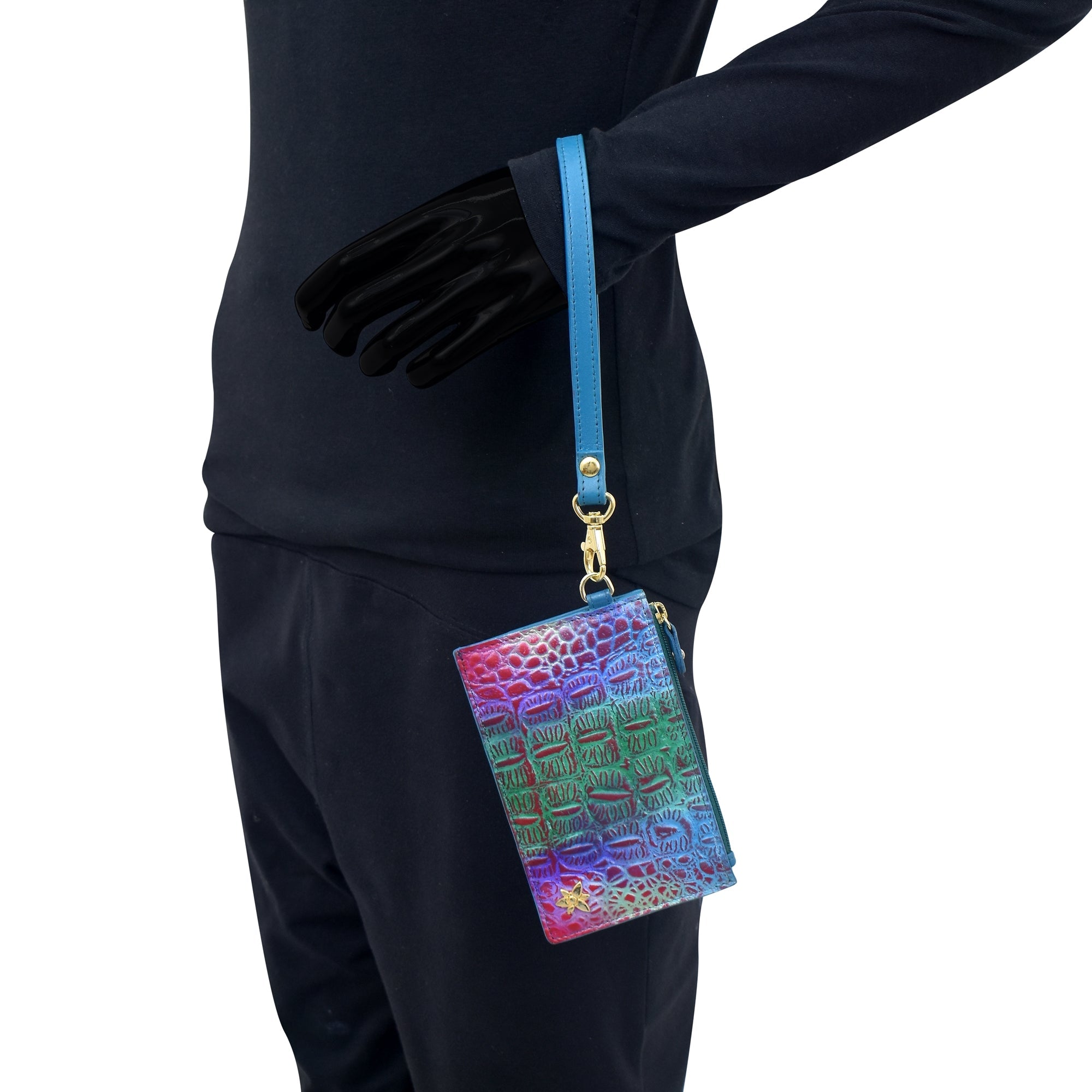 Person in black long-sleeve shirt and pants holding an Anuschka Card Holder with Wristlet - 1180 with a blue strap.