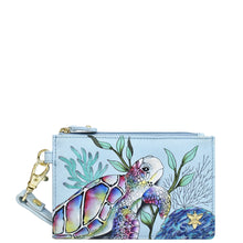 Load image into Gallery viewer, An Anuschka Card Holder with Wristlet - 1180 featuring an illustrated sea turtle design, RFID protection, and a convenient wrist strap.
