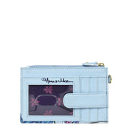 A light blue genuine leather cardholder with a transparent ID window, zipper compartment, and floral pattern. It features the brand name "Anuschka" and comes with RFID protection. The product name is "Card Holder with Wristlet - 1180.