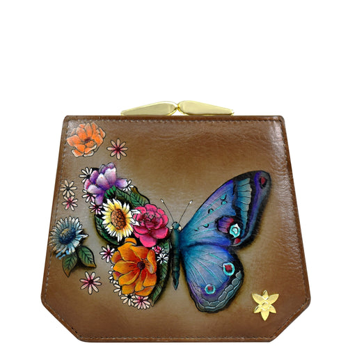 The Anuschka Two Fold French Wallet - 1181 is a brown genuine leather clutch purse adorned with a colorful butterfly and various floral designs, featuring a classic French clasp coin pocket for added elegance.