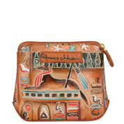 The Multi Purpose Zip Pouch - 1182 by Anuschka is a small, rectangular slim pouch made of genuine leather, showcasing colorful hand-painted Egyptian-themed artwork with motifs such as a reclining animal and various symbols. It features a top zipper and a small branded patch sewn on. This minimalist essential adds flair to any outfit.