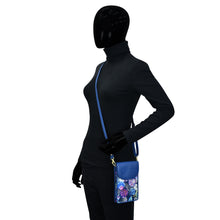 Load image into Gallery viewer, Mannequin displaying a black bodysuit and a small blue patterned shoulder bag with RFID protection - Anuschka Fabric with Leather Trim Cell Phone Crossbody Wallet - 13005.
