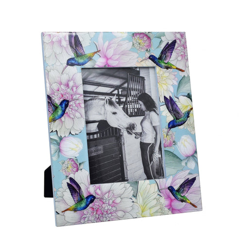 Decorative Anuschka wooden printed photo frame with floral and hummingbird pattern containing a black and white photograph of a person and a horse.