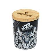 A cylindrical Printed Glass Candle Jar - 25005 with a leopard print design and a wooden lid, bearing the brand name "Anuschka.