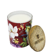 A hand-painted, luxurious Anuschka Printed Glass Candle Jar - 25005 with a wooden lid on a white background.