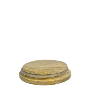 Two wooden coasters stacked on a white background, beside an Anuschka Printed Glass Candle Jar - 25005.