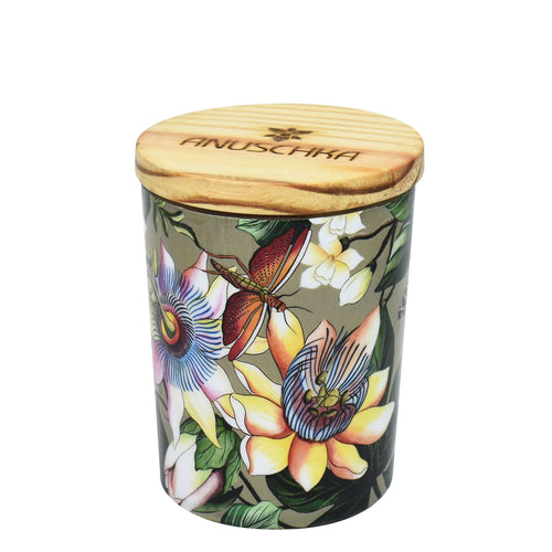 Decorative Anuschka printed glass candle jar with floral and butterfly design and a wooden lid, ideal for candles or essential oils.