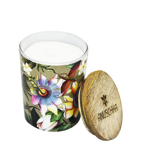 Decorative floral candle with a Printed Glass Candle Jar - 25005 and a wooden lid bearing the inscription "Anuschka.
