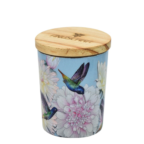 Decorative printed glass candle jar with hummingbird and floral print, featuring a wooden lid by Anuschka.