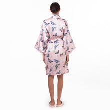 Load image into Gallery viewer, A person standing with their back to the camera, wearing a pink Anuschka robe with a bird pattern.
