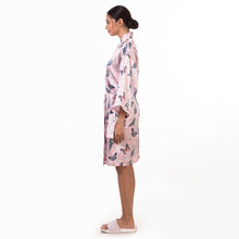 Load image into Gallery viewer, A woman standing in profile wearing an Anuschka floral 3343 robe, embodying self-care and relaxation.
