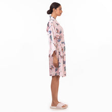 Load image into Gallery viewer, Woman standing side profile wearing a floral Anuschka robe and white sandals, embodying relaxation and self-care.
