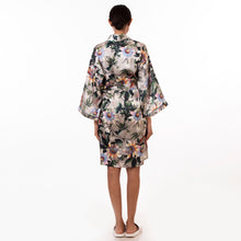 Load image into Gallery viewer, A person standing with their back toward the camera, wearing a silky, floral Anuschka kimono-style robe - 3343.
